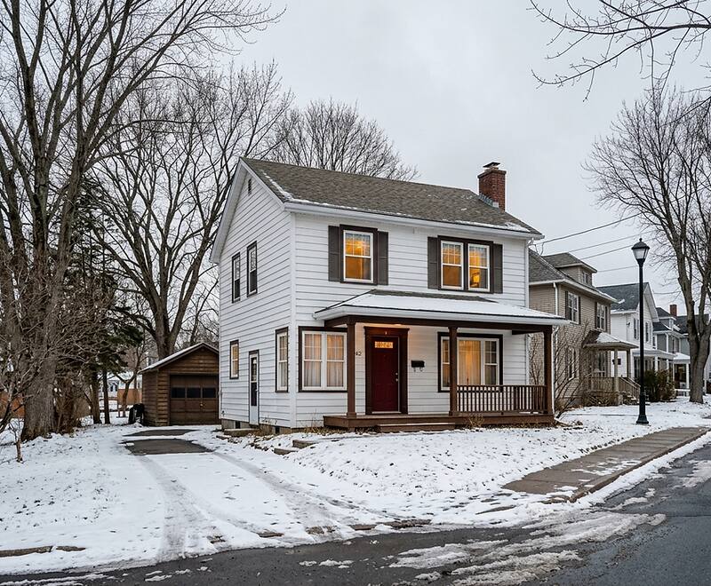 Older home in Southern New Brunswick with winter ice dam damage, common for newcomer buyers to encounter