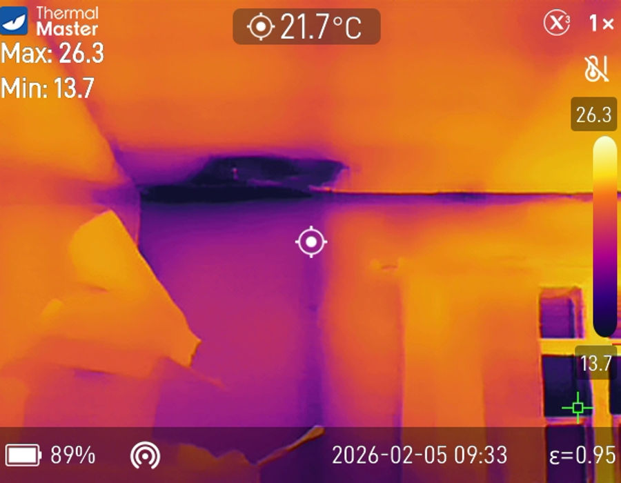 Same ceiling viewed in infrared, with cooler discoloured patches indicating water intrusion