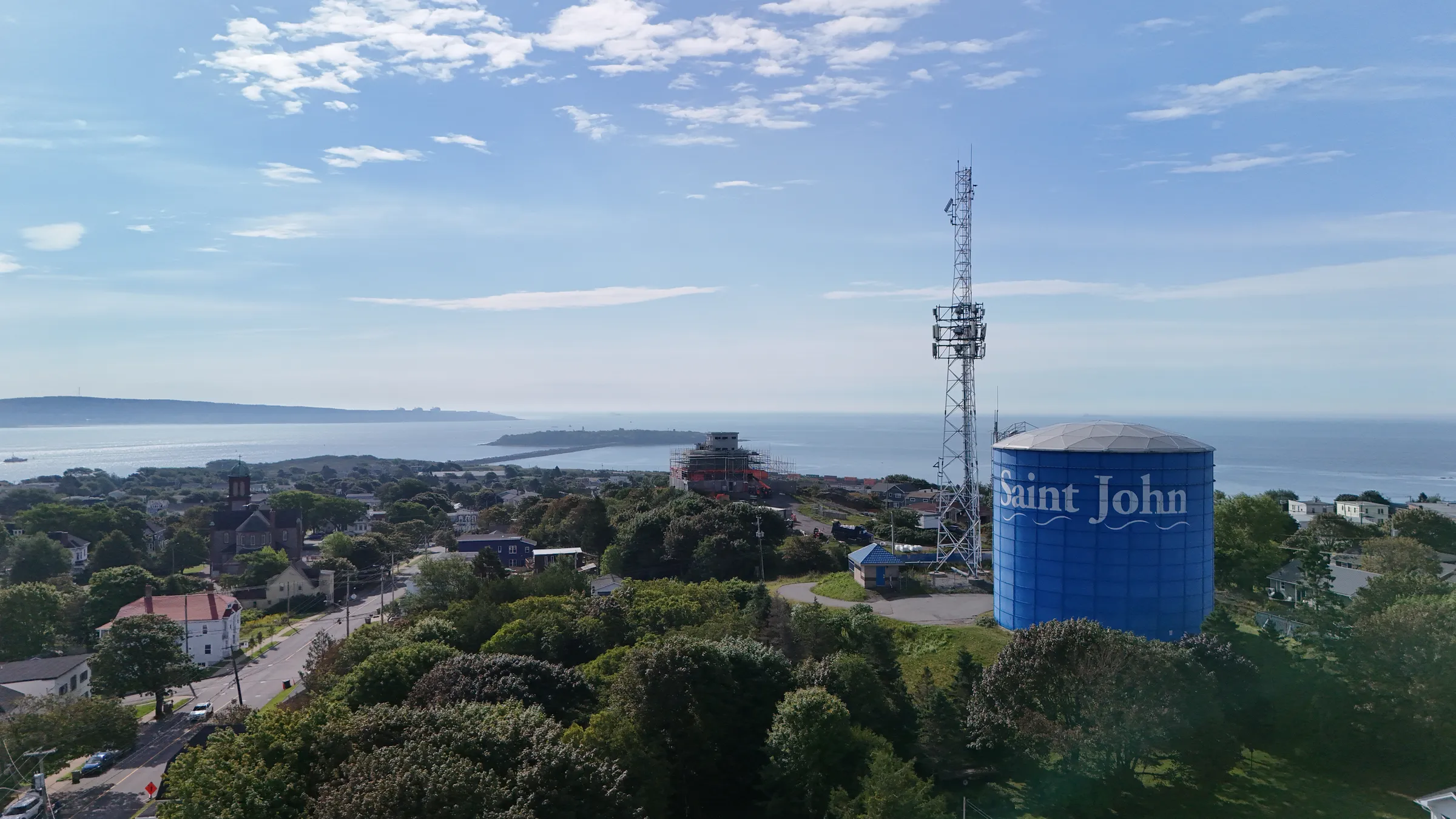 Aerial view over Saint John, the blue Saint John water tower and the Bay of Fundy beyond
